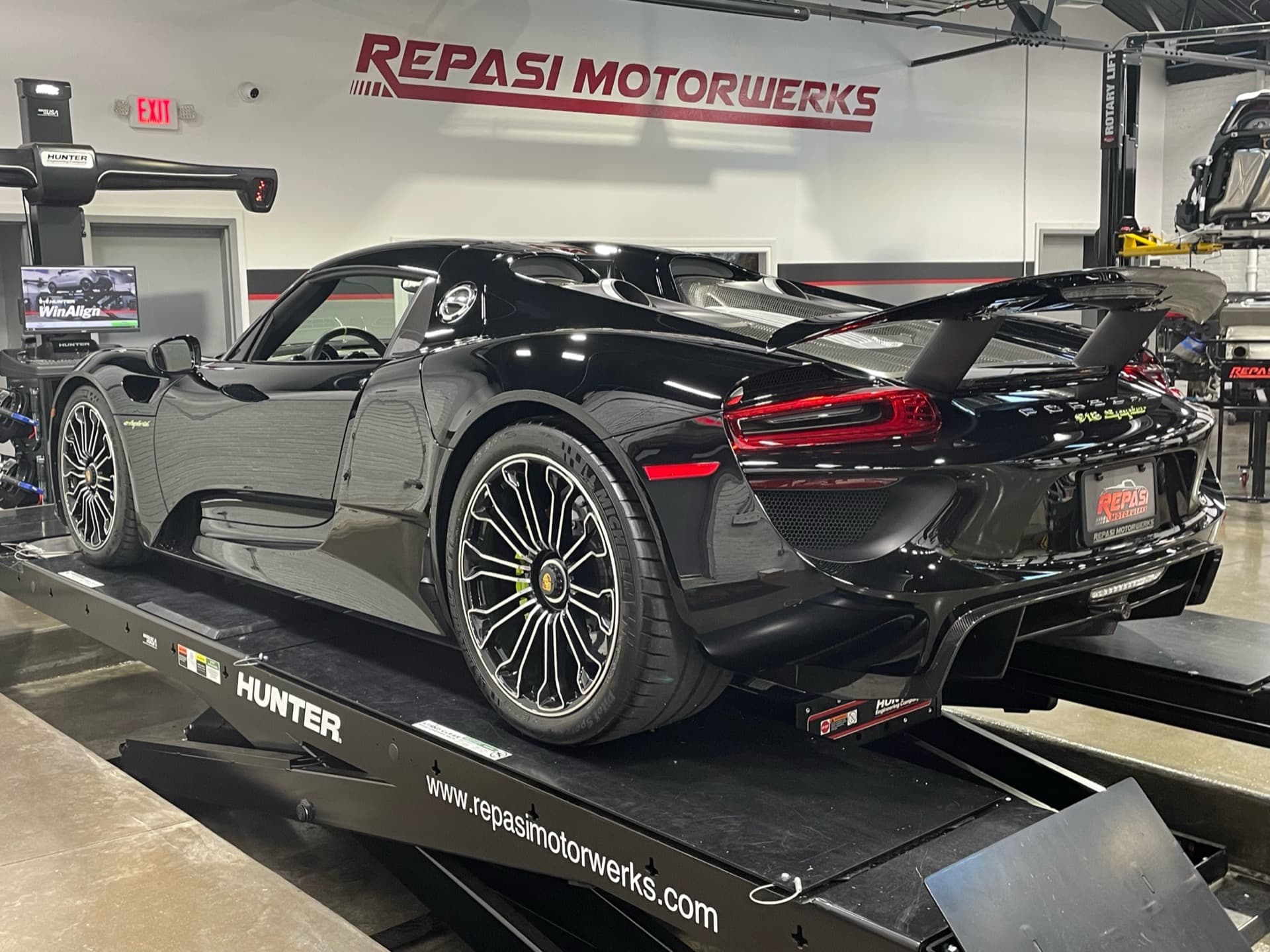 Black Porsche 918 Spyder Weissach package on a Hunter alignment rack at Repasi Motorwerks