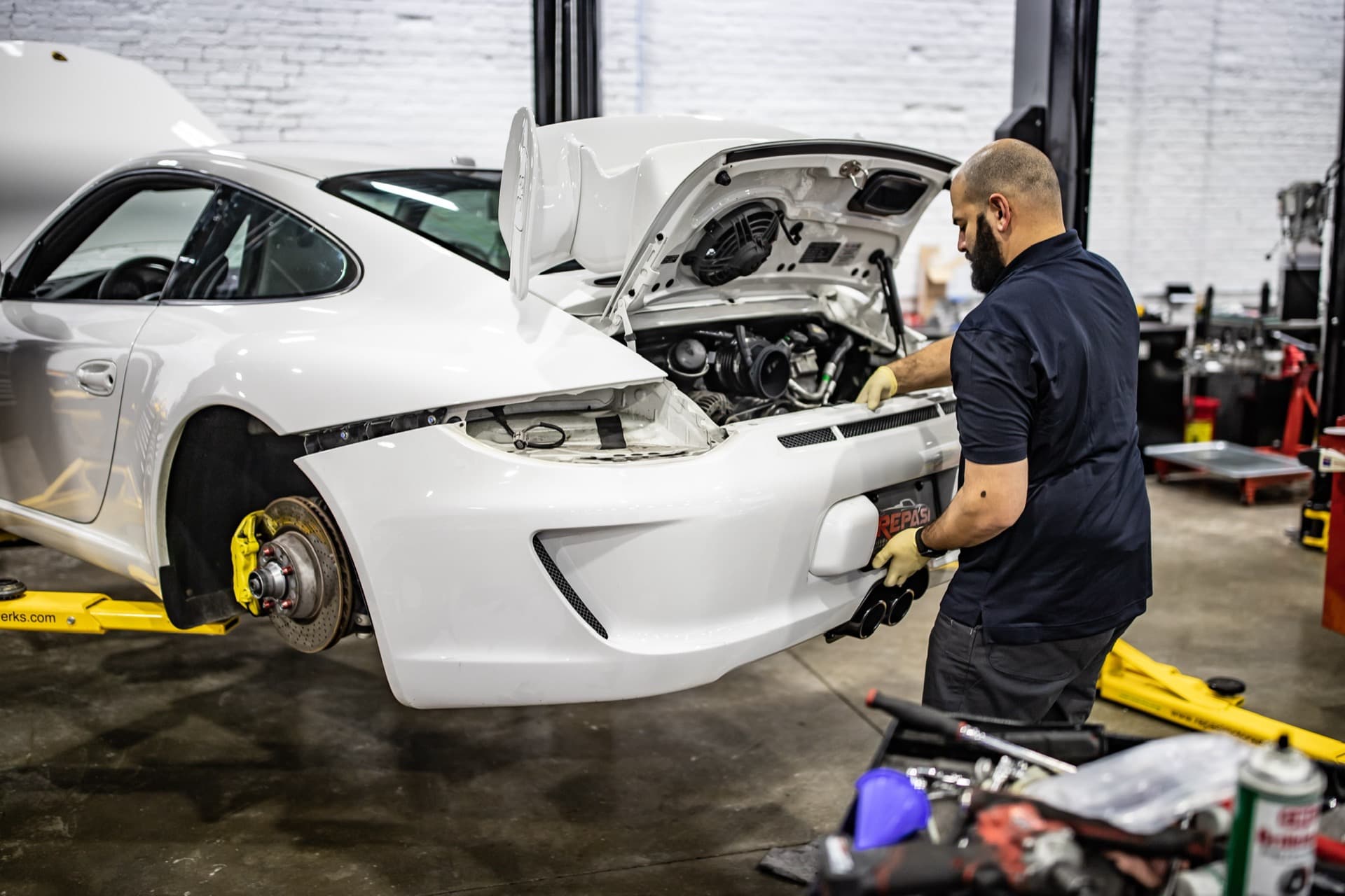 White Porsche 991 GT3 with front bumper removed during maintenance service at Repasi Motorwerks